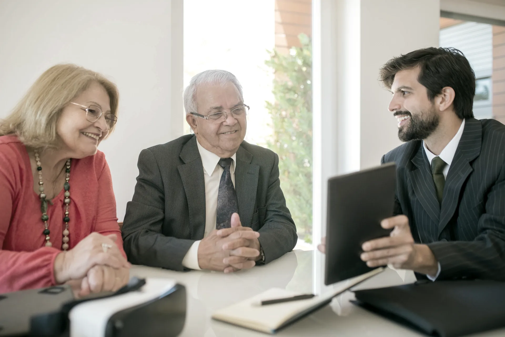 Two businessmen discussing documents over coffee